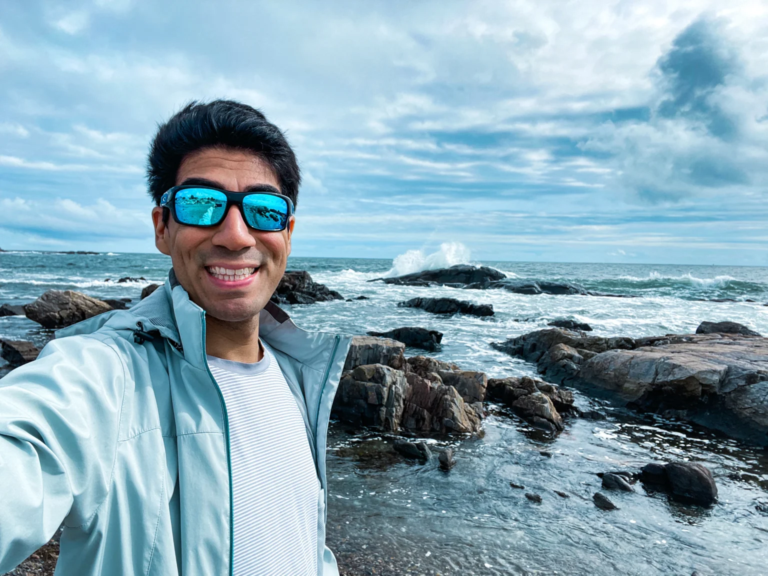 Adrian Holmes standing at waters edge at Nubble Point Maine